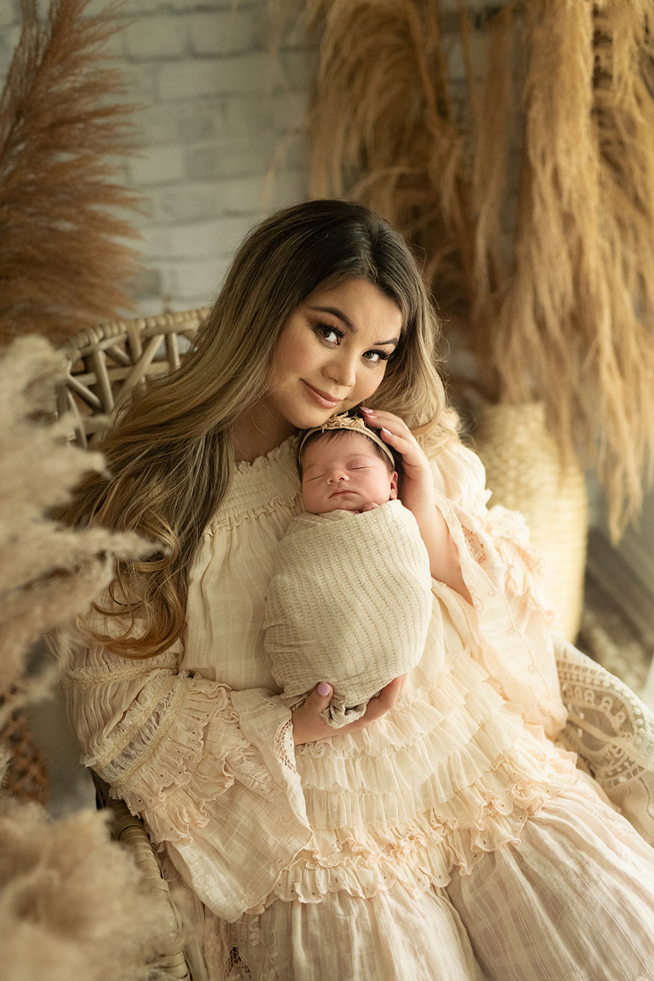 New mother with baby in boho studio by window light